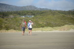 Couple going for a pleasant walk along Cloudy Bay Beach