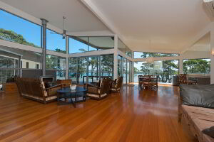 Spacious lounge area with high ceilings and floor to ceiling windows