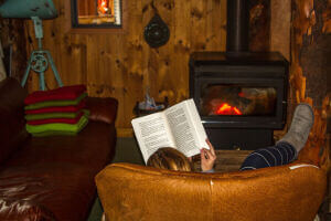 Relaxing with a book by the cosy fire